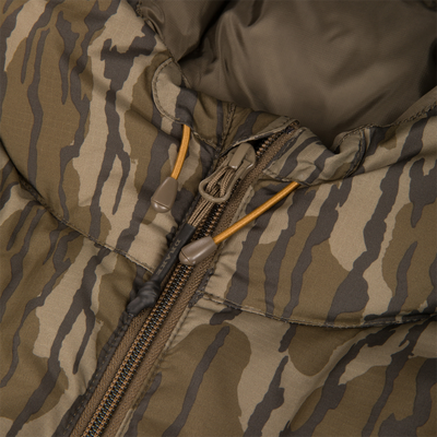 Close-up of BMF Down Jacket's tiger-stripe camo ripstop nylon, featuring central zipper and toggled drawcords, highlighting its durable, insulated design for hunting.