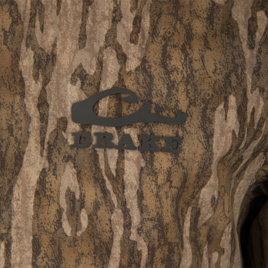 Close-up of the LST BMF Eqwader Full Zip with Primaloft, featuring a camouflage pattern and Drake Waterfowl Systems logo, highlighting its waterproof, windproof, breathable design.