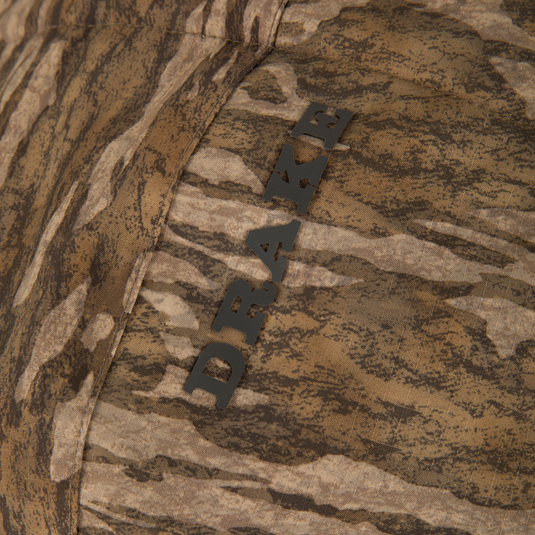 Close-up of LST BMF Eqwader Half Zip Jacket with Primaloft featuring a DRAW. seam detail, showcasing its woodland camouflage pattern and durable construction.