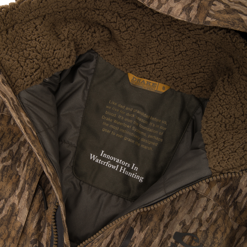 Close-up of the LST BMF Eqwader Half Zip Jacket's interior, highlighting the sherpa fleece collar, zippered front, and Drake Waterfowl label with heritage details.