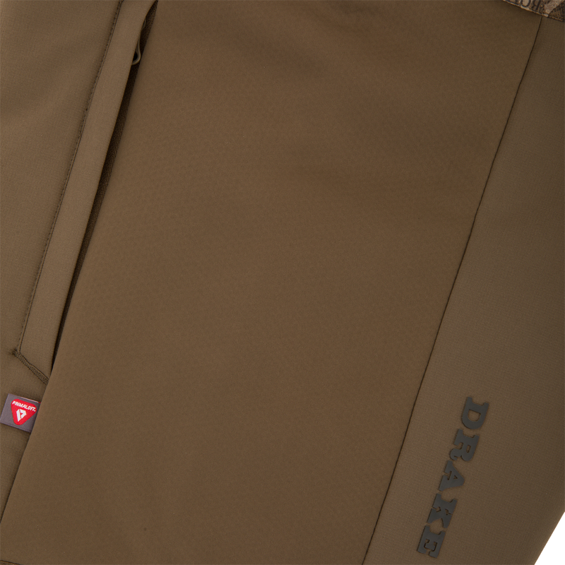 LST BMF Eqwader Half Zip Jacket with Primaloft, showcasing a brown soft-shell with camo lining, vertical seam pocket, and embossed PRAXE branding.
