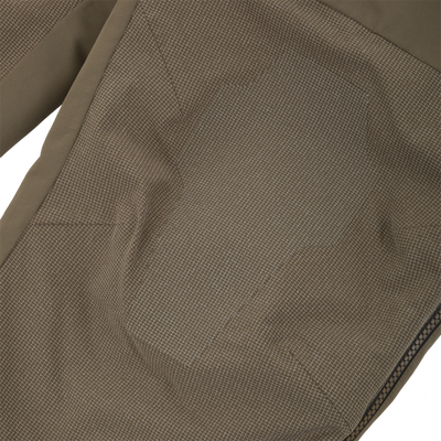Close-up of olive green Drake X Ducks Unlimited LST BMF Pit Bib with Primaloft pants featuring a reinforced, textured panel on the knee and a side zipper.