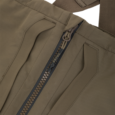 Close-up of the front zipper on olive green Drake X Ducks Unlimited LST BMF Pit Bib with Primaloft waterfowl hunting bibs.
