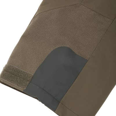 Close-up of olive green Drake X Ducks Unlimited LST BMF Pit Bib with Primaloft outdoor pants featuring a reinforced dark patch on the knee and a velcro closure at the leg opening.