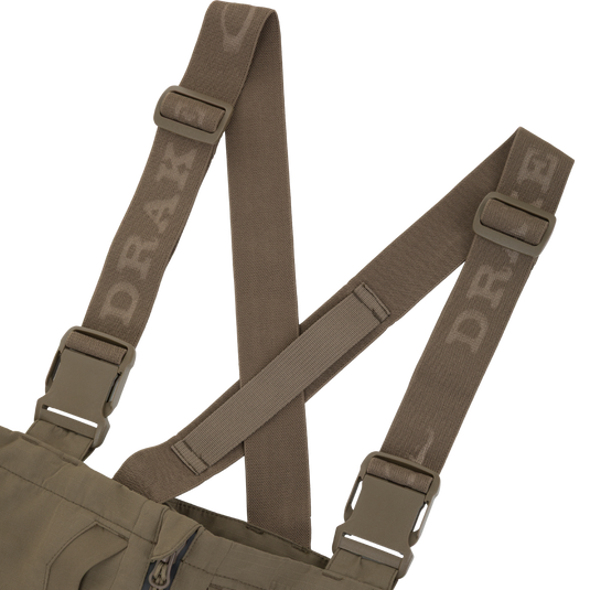 Olive green Drake X Ducks Unlimited LST BMF Pit Bib straps with plastic buckles and embossed brand lettering.
