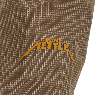 Close-up of the LST BMF 3-in-1 Pit Jacket, showcasing a heavy-metal–style HEAVY METTLE logo on durable, textured woven fabric.