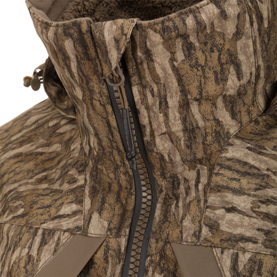 Close-up of LST BMF 3-in-1 Pit Jacket with Primaloft, showcasing camo pattern, high collar, heavy-duty zipper, and cord toggle for versatile outdoor protection.