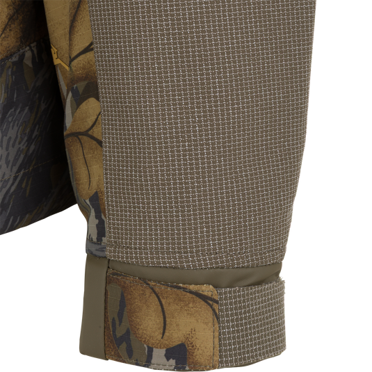 Close-up of a Drake X Ducks Unlimited LST BMF 3-in-1 Pit Jacket with Primaloft sleeve, featuring a textured brown forearm panel and an adjustable cuff.