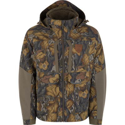Mossy Oak Fall Foliage Drake X Ducks Unlimited LST BMF 3-in-1 Pit Jacket with Primaloft featuring a camo pattern, hood, chest pockets, zipper closure, and solid-colored panels on the sleeves.