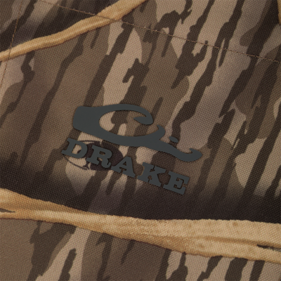 Close-up of camouflage fabric from a fleece hunting vest, featuring a logo that reads Waterfowl below a stylized duck design. Product shown: CommandXT Eqwader Vest.