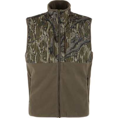 The Waterfowl CommandXT Eqwader Vest features a sleeveless fleece design with camo on top, olive on bottom, front zip closure, and two zippered pockets.