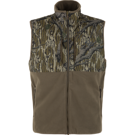 The Waterfowl CommandXT Eqwader Vest features a sleeveless fleece design with camo on top, olive on bottom, front zip closure, and two zippered pockets.