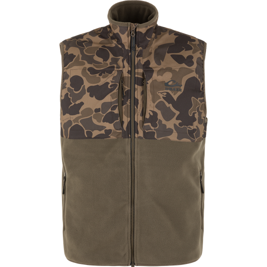 A sleeveless zip-front vest with a brown and tan camouflage pattern on the upper chest and shoulders, and an olive green lower body, shown on a plain white background.