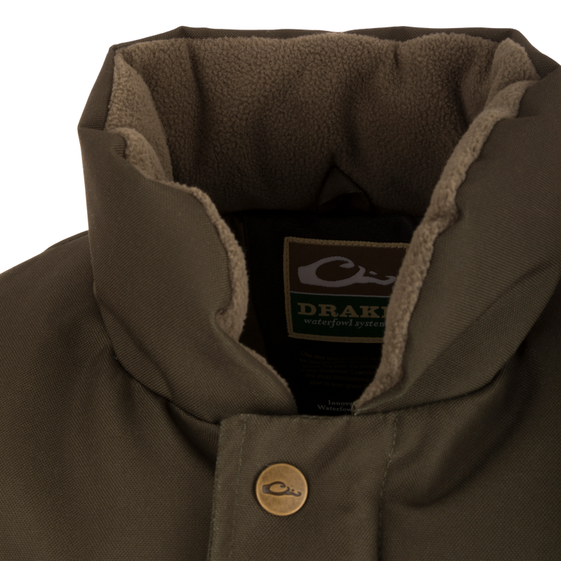 Close-up of the Throwback 80 Featherless Puffer Jacket's fleece-lined collar, showcasing Drake label, snap-button placket, and soft inner lining for warmth.