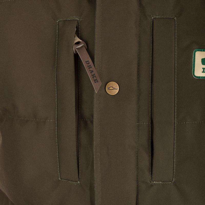 Throwback 80 Featherless Puffer Vest close-up showing durable zipper, fleece collar lining, and large pockets, highlighting waterproof and insulated features for optimal warmth.