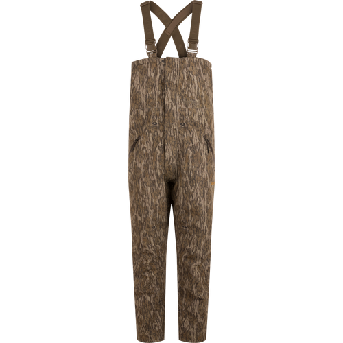 LST Hardline Insulated Bib designed for wooded hunting, features durable waterproof fabric, synthetic insulation, and functional zippers for easy wear in harsh environments.