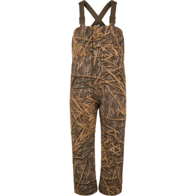 LST Hardline Insulated Bib with adjustable straps, grass camo print, waterproof polyester, synthetic down insulation, tricot-lined pockets, and articulated knees for waterfowl hunting.