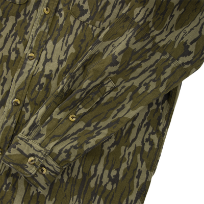 Throwback 80 Button Down Shirt in tiger-stripe camo, showcasing durable 8.3oz cotton twill, triple-needle stitching, and reinforced forearm and elbow for hunting wear.