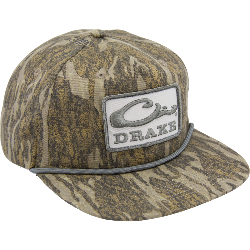 Drake X LOST Goat Rope Cap featuring a camouflage pattern, flat brim, snap-back closure, and a stylized Drake logo with rope detail above the bill.