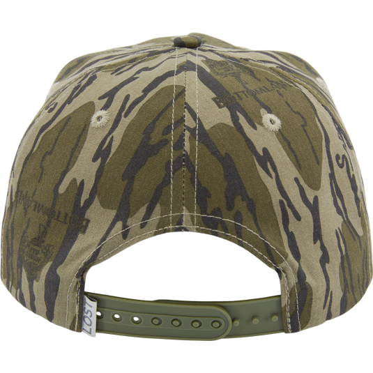 Drake X LOST Goat Rope Cap in tiger-stripe camouflage, features snapback closure, paracord detail, and ventilation eyelets, blending rugged style with functionality.