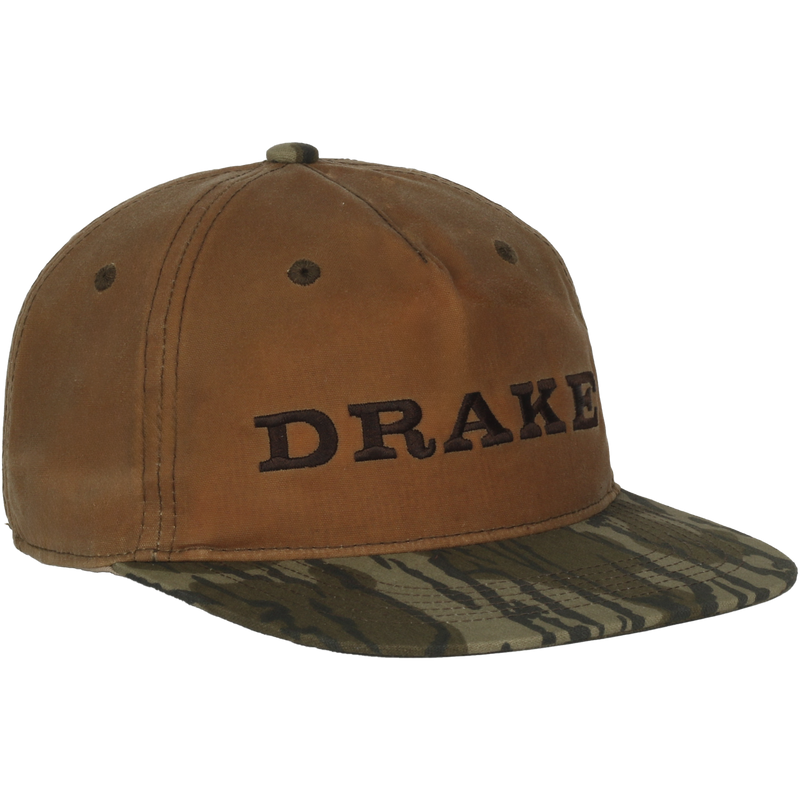 Waxed Flatbill Ball Cap with a brown crown and tiger-stripe camo brim, featuring DRAKE embroidered on the front, exemplifying Drake Waterfowl's stylish hunting gear.