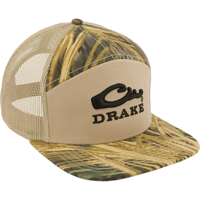 The Drake X Lost Hat Sa7age 7 Panel Cap by Waterfowl features a Mossy Oak Original Shadow Grass pattern, mesh sides, curved brim, mid-crown profile, black Drake embroidery, and a snap-back closure.