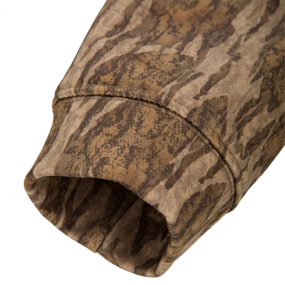 Close-up of the Youth Performance Hoodie's camo cuff, highlighting the durable seam stitching and tiger-stripe pattern, showcasing its resilience and flexibility for active wear.