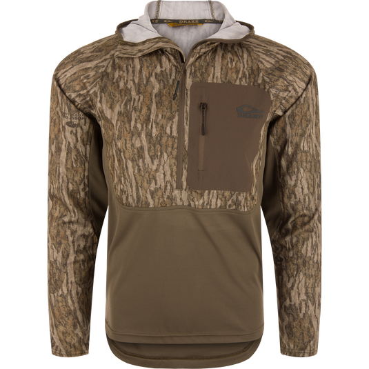 The EST Performance Half-Zip Hoodie by Waterfowl features Mossy Oak Bottomland camo, a chest pocket, water-resistant fabric, and durable construction—ideal for hunting or hiking outdoors.