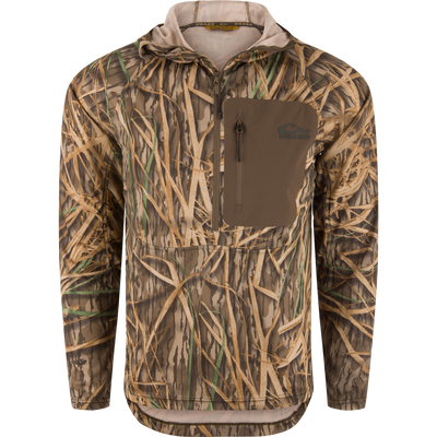The Waterfowl EST Performance Half-Zip Hoodie in Mossy Oak Original Shadow Grass features a front zipper, chest pocket, water-resistant finish, and camo pattern—ideal for outdoor or hunting use.