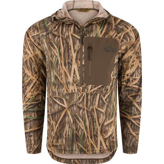 The Waterfowl EST Performance Half-Zip Hoodie in Mossy Oak Original Shadow Grass features a front zipper, chest pocket, water-resistant finish, and camo pattern—ideal for outdoor or hunting use.