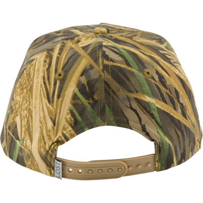The Drake x Lost Hat BMF Goat Rope Cap by Waterfowl in camouflage features green, brown, and tan shades, an adjustable snapback strap, and a small white tag on the left side.