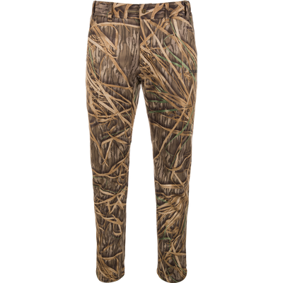 The Waterfowl BMF Ultimate Wader Pants feature a grass and reed camouflage pattern with a durable polyester fleece shell—ideal for hunting or outdoor use. Displayed on a plain white background.