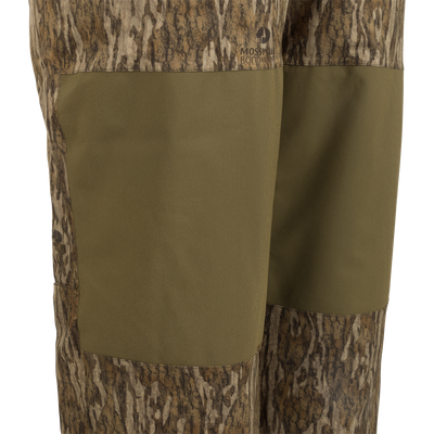 A pair of Reflex™ Insulated Bibs made of waterproof, windproof, and breathable fabric. Features include adjustable suspenders, reinforced knees and seat, and knee-length side leg zippers.