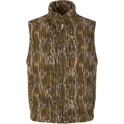 The MST Windproof Layering Vest by Lifestyle is a sleeveless, zip-up layering vest in brown, tan, and black camo with water-resistant fleece and a small embroidered chest logo.