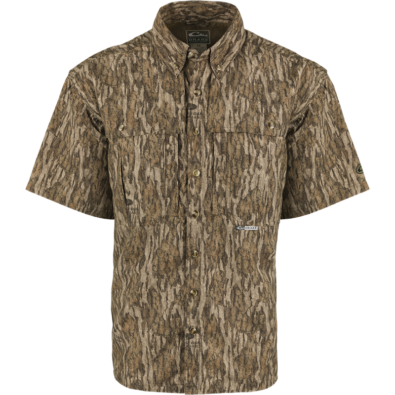 Camouflage Drake EST Camo Wingshooter's Short Sleeve Shirt with front vents, mesh back, chest pockets, and button-down collar designed for hunting and outdoor activities.