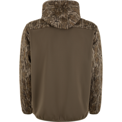 Back view of the Waterfowl MST Endurance Soft Shell Hoodie featuring camo-patterned sleeves, hood, and upper back. Its fleece-lined hood and relaxed fit are ideal for outdoor use; middle and lower back are solid olive green.