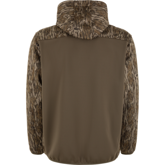 Back view of the Waterfowl MST Endurance Soft Shell Hoodie featuring camo-patterned sleeves, hood, and upper back. Its fleece-lined hood and relaxed fit are ideal for outdoor use; middle and lower back are solid olive green.