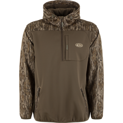 The MST Endurance Soft Shell Hoodie by Waterfowl features a brown body, camo-patterned sleeves and fleece-lined hood, zippered chest and hand pockets, plus an embroidered logo on the left chest. Perfect for outdoor use.