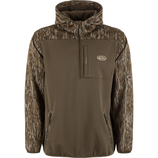The MST Endurance Soft Shell Hoodie by Waterfowl features a brown body, camo-patterned sleeves and fleece-lined hood, zippered chest and hand pockets, plus an embroidered logo on the left chest. Perfect for outdoor use.