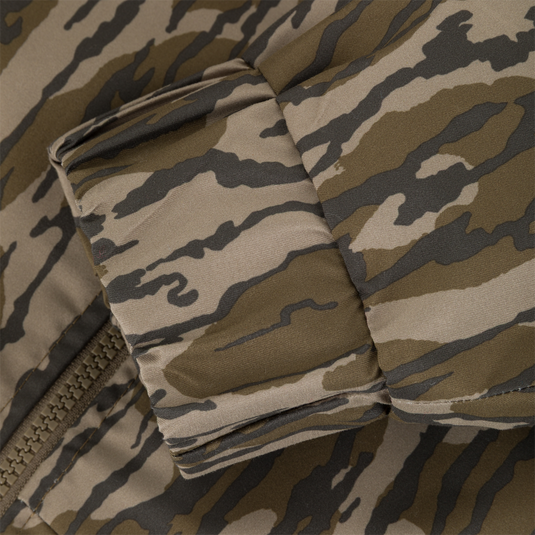 Close-up of an MST Waterproof Full Zip Jacket w/ Hood sleeve cuff with a zippered closure and a brown and olive green camouflage pattern.