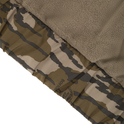 Close-up of the interior of an MST Waterproof Full Zip Jacket w/ Hood, showing a soft brown fleece lining next to a patterned waterproof shell.