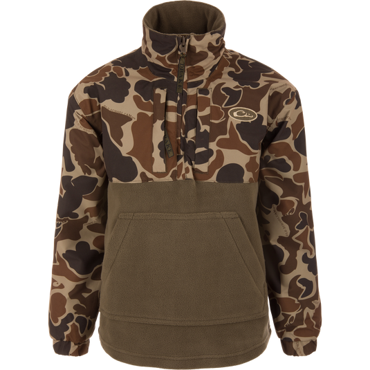 MST Youth Eqwader Quarter Zip Jacket with camo print sleeves, olive fleece body, kangaroo pocket, and dual-zone waterproof and breathable fabric for enhanced comfort in waterfowl hunting.