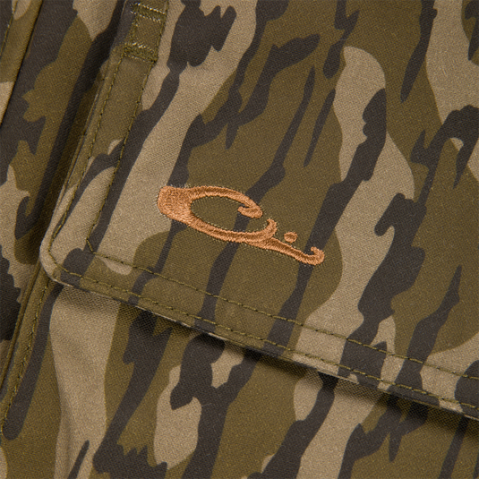 Close-up of a pocket flap on the MST Drake Dry Waxed Cotton Wading Jacket featuring an embroidered brown duck head logo.