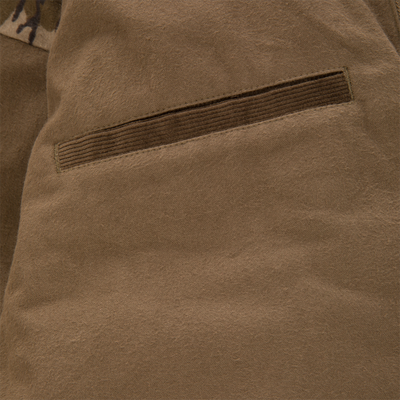 Close-up of a brown, Thinsulate-insulated Waterfowl LST Insulated Waxed Cotton Jacket featuring a corduroy-trimmed welt pocket.
