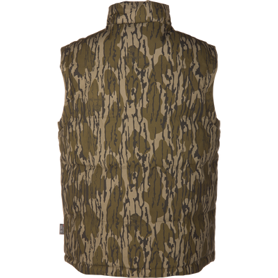 The LST Insulated Waxed Cotton Vest by Waterfowl is sleeveless, insulated, and features a green and brown camouflage pattern, shown from the back against a plain white background.