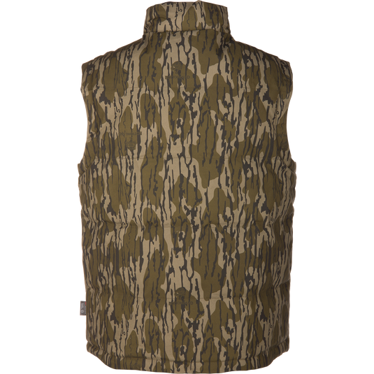 The LST Insulated Waxed Cotton Vest by Waterfowl is sleeveless, insulated, and features a green and brown camouflage pattern, shown from the back against a plain white background.