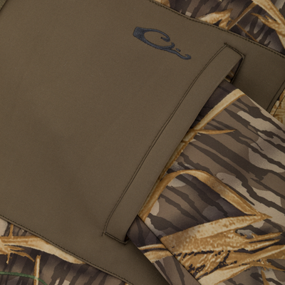 Close-up of a solid olive-green pocket on a camouflage patterned Slacker Wader Pocket Hoodie.