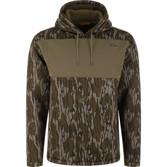 Slacker Wader Pocket Hoodie in a Mossy Oak Original Bottomland camouflage pattern with a solid olive green chest panel and a drawstring hood.