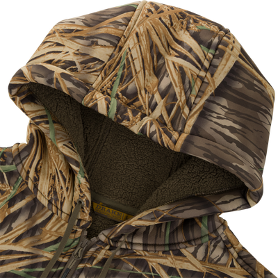 A close-up of the Slacker Quarter Zip Hoodie by Waterfowl, featuring a brown and green camo pattern with soft, dark olive fleece lining for ultra-comfy, anti-pilling style.