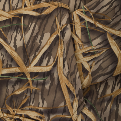 Close-up of camouflage fabric with brown reeds, green accents, and wavy dark lines, perfect for the Waterfowl Slacker Quarter Zip Hoodie.